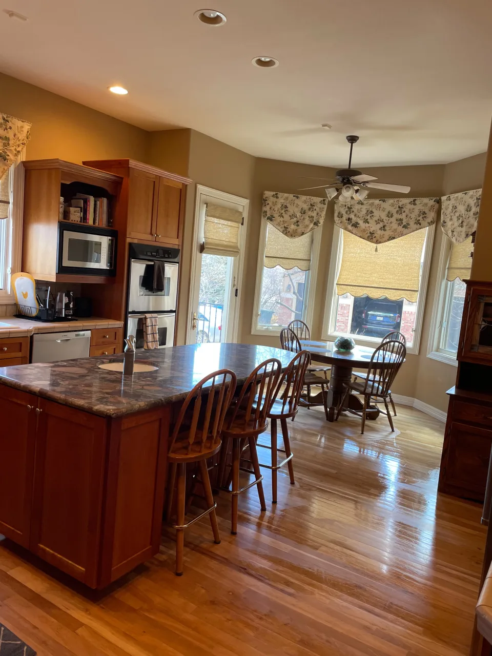 Spacious commercial kitchen with a granite island and dining area, clean and tidy space for businesses